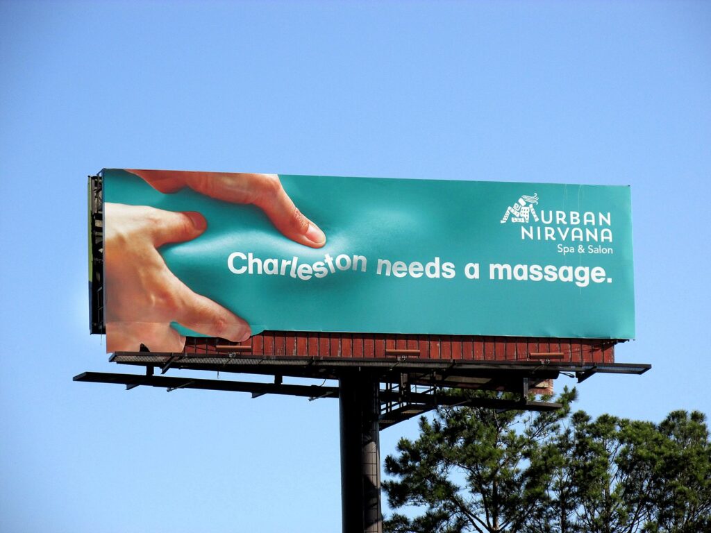 Creative OOH Ad - billboard showing a hand doing message to the billboard itself